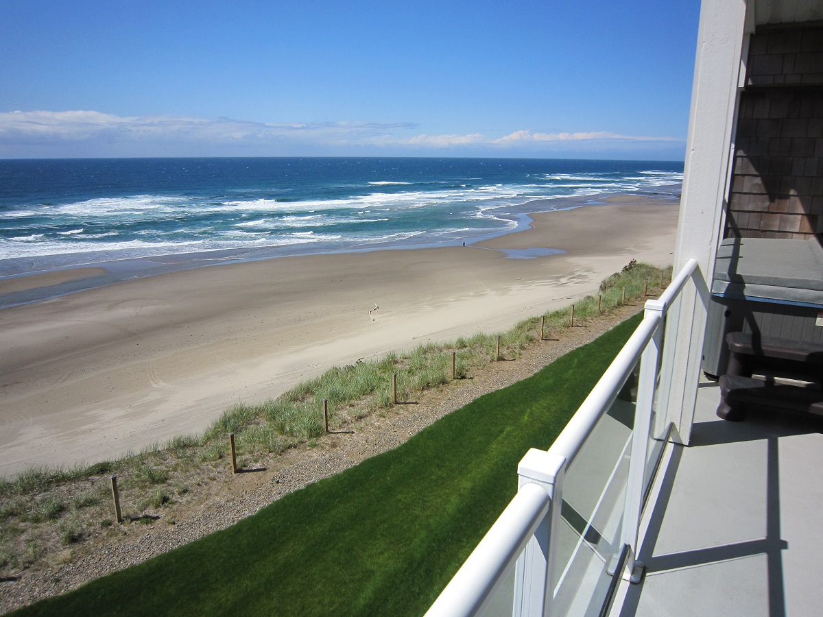 view of beach and ocean from balcony of vacation rental