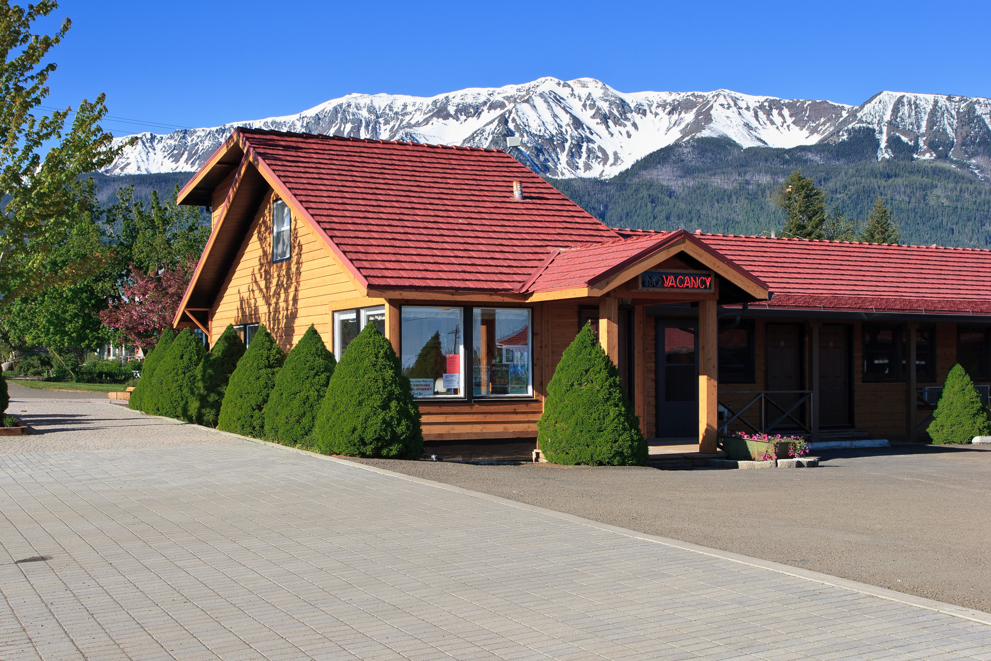 exterior of hotel front office with mountains in background
