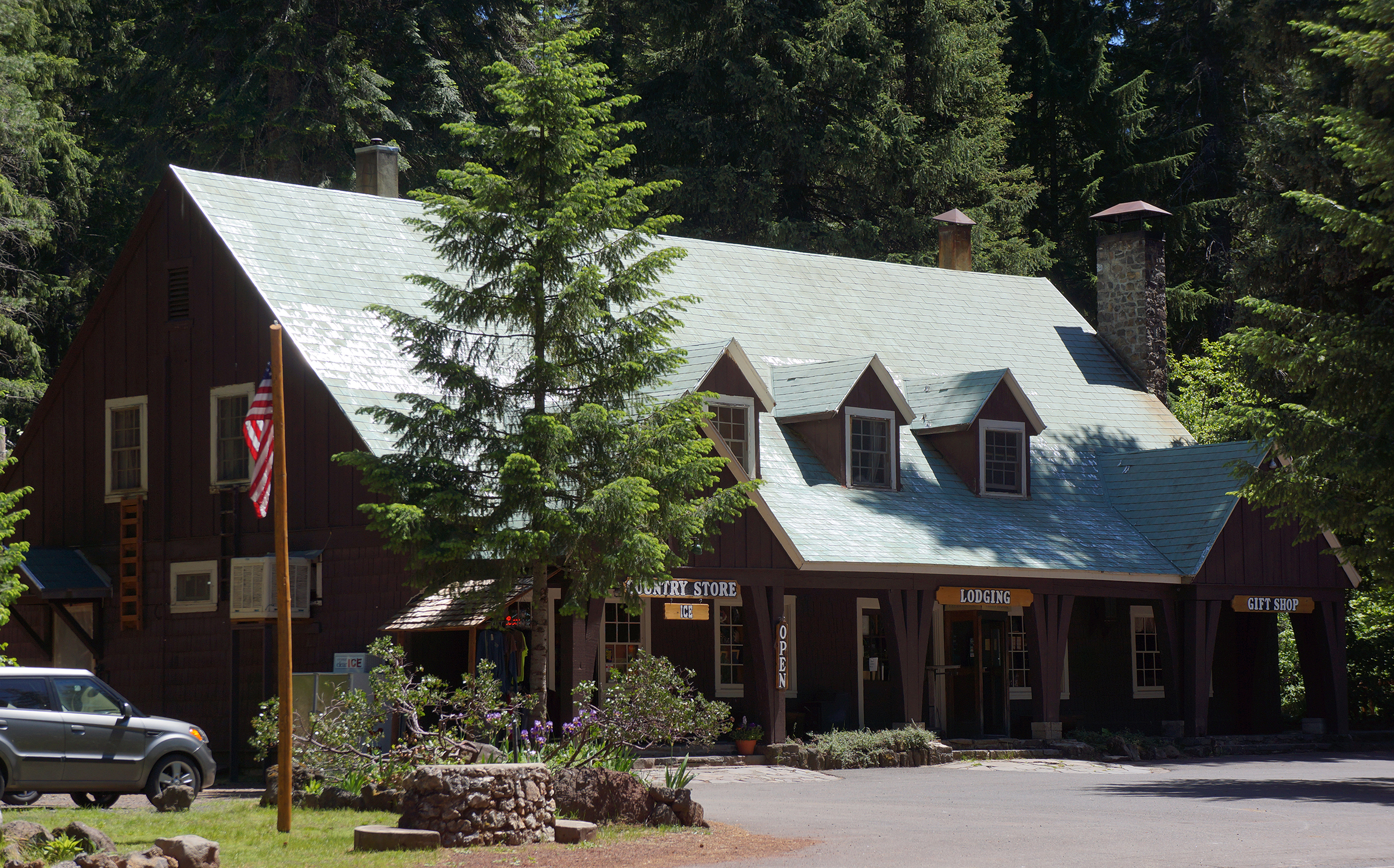 exterior of two story rustic wood building with front porch