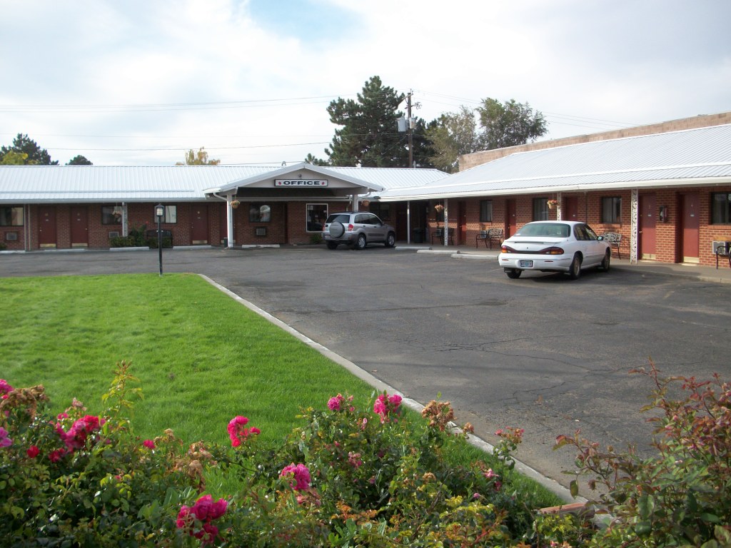 exterior of one story motel with parking lot in front