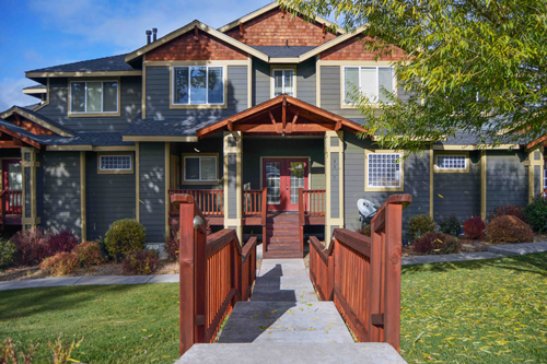 exterior of two story vacation rental home with long walkway leading to porch