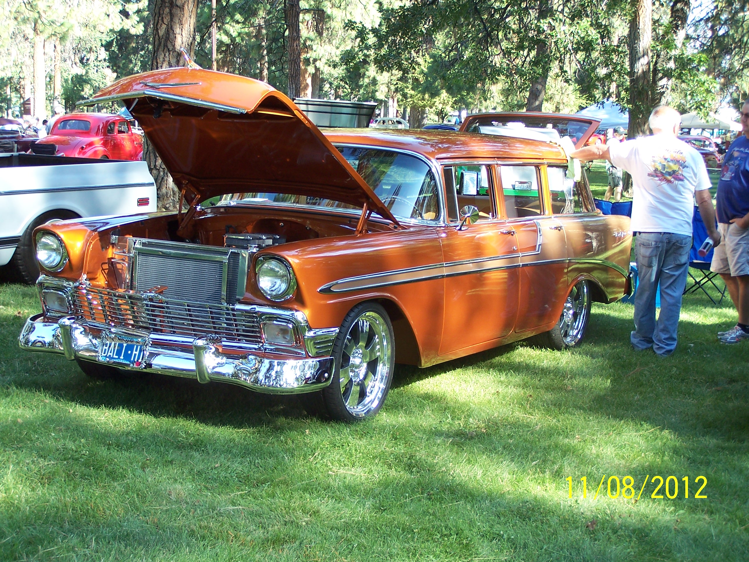 Restored vintage station wagon displayed at a car show.