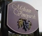 wooden sign with cursive text for Melrose Vineyards