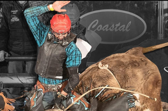 young gentleman on a brown bull wearing a red helmet and black vest