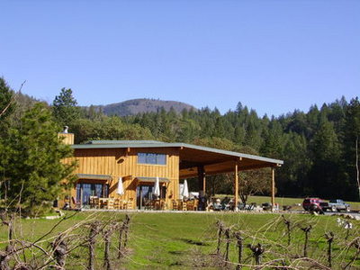 exterior of two story building with large covered patio