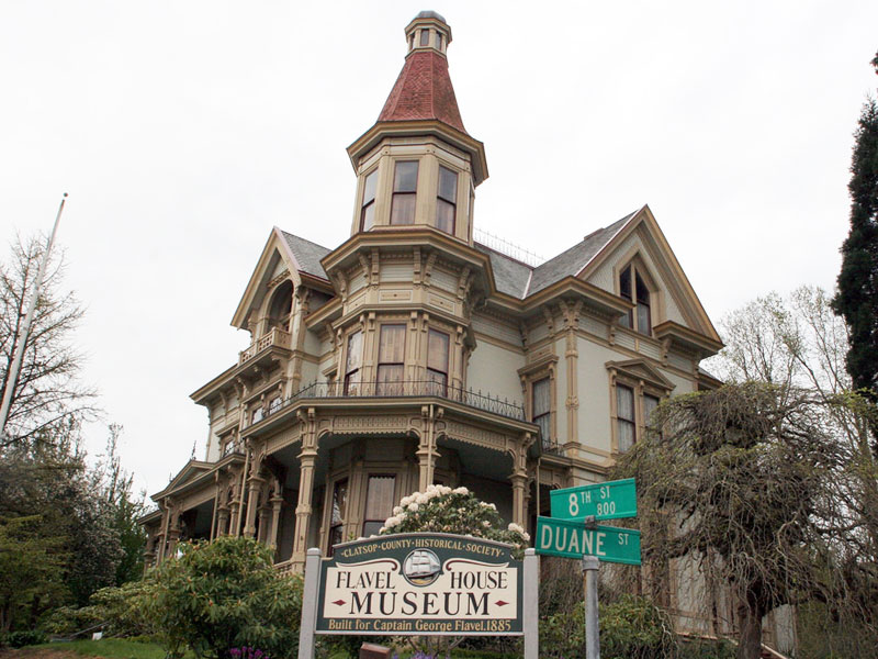 exterior of historic victorian mansion with sign in front for Flavel House Museum