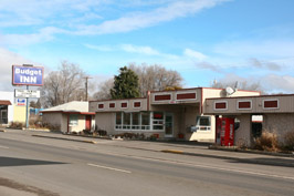 Budget Inn motel with sign on empty street.