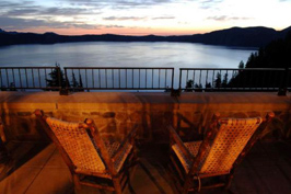 balcony with two chairs overlooking large lake