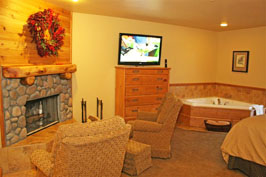 hotel room with fireplace, 2 recliners and bathtub