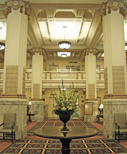 opulent hotel lobby with tall stone pillars