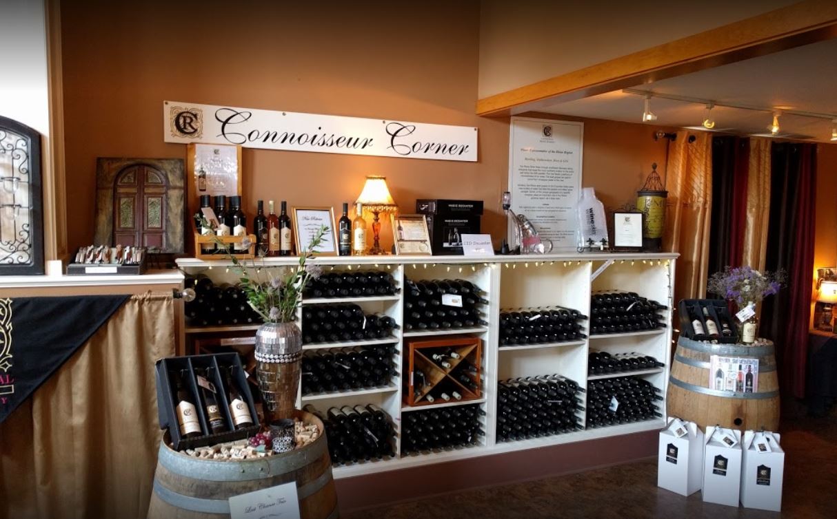 interior of wine tasting room with retail shelves and free standing displays of bottles for sale