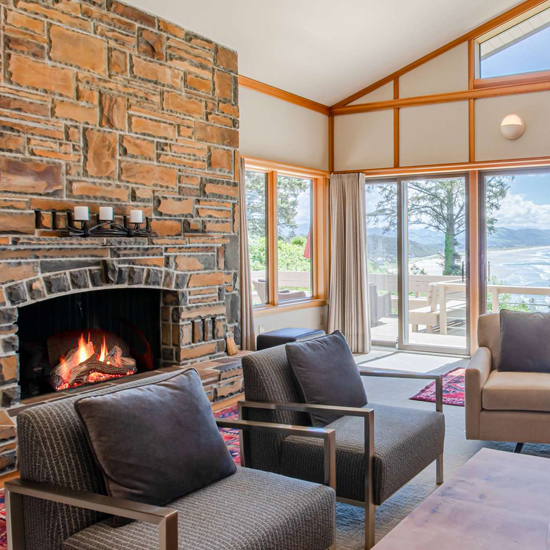 living room with high ceilings, brick fireplace and large windows