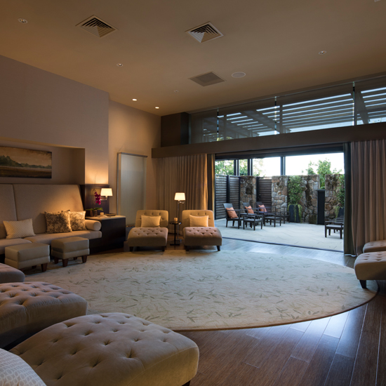 large room with chaise lounges and outdoor patio