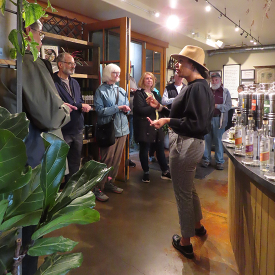 tour guide speaks to small group in winery tasting room