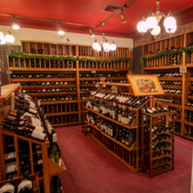 retail display of wine bottles on wooden racks