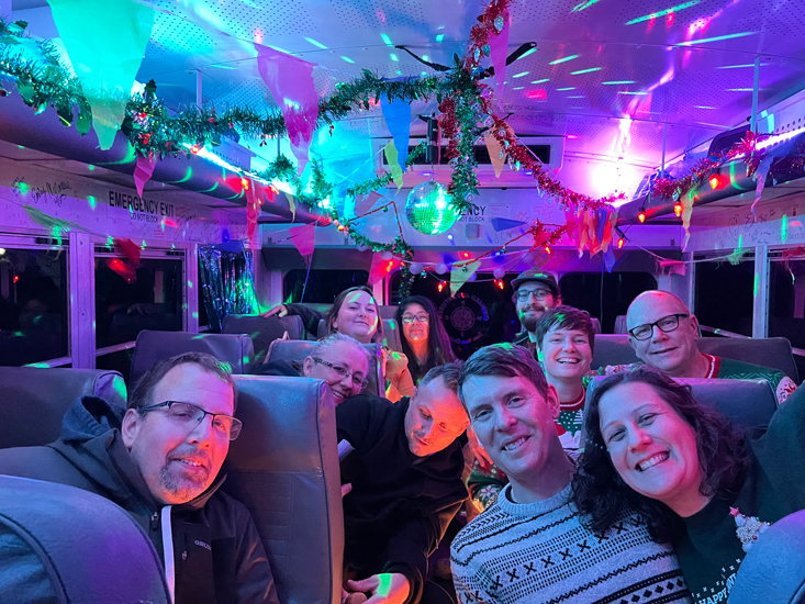 group on a party bus decorated for the holidays