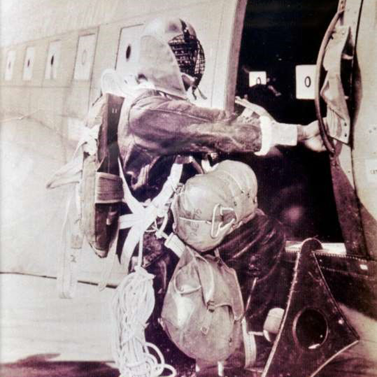 historical photo of airman climbing into aircraft