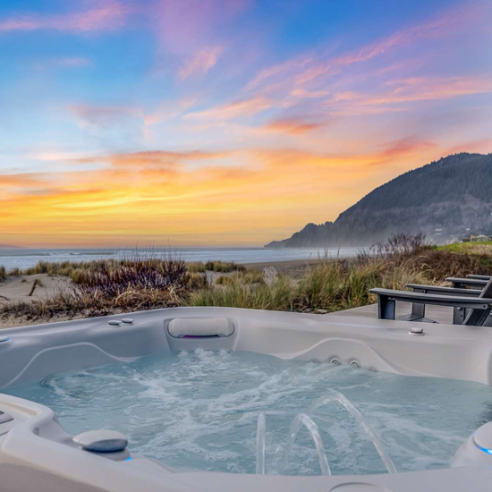 hot tub with sunset and water view