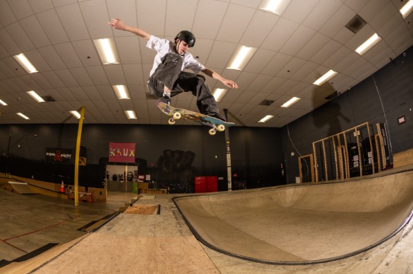 person skateboards in indoor skate park