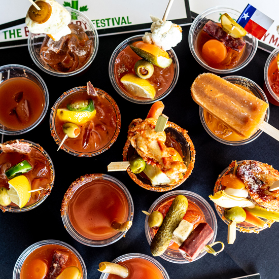 overhead image of many small bloody mary beverages