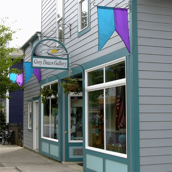 storefront with tall windows and sign for Grey Dawn Gallery
