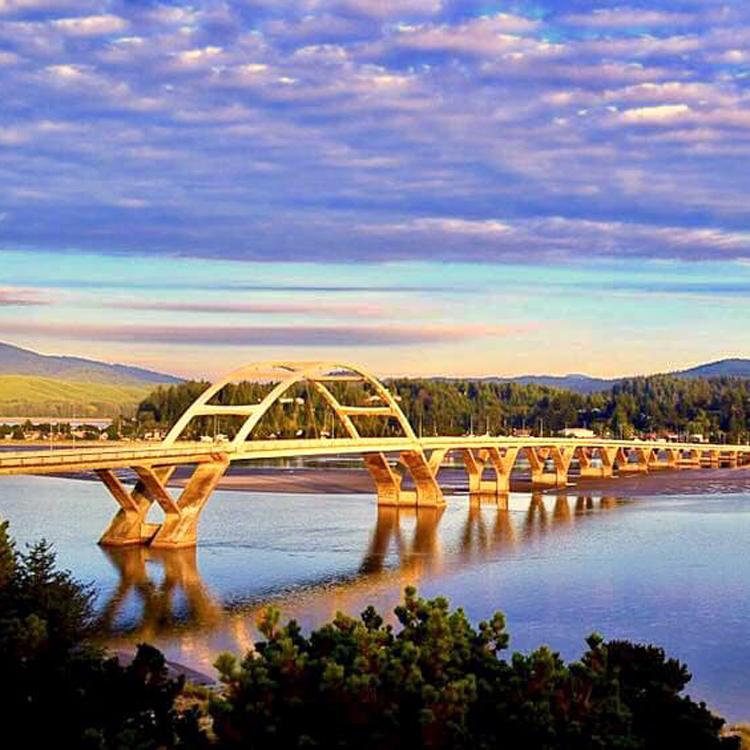 view of bridge with sunset and clouds above