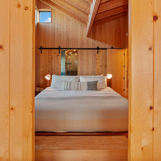 bedroom with wood paneling and sliding door