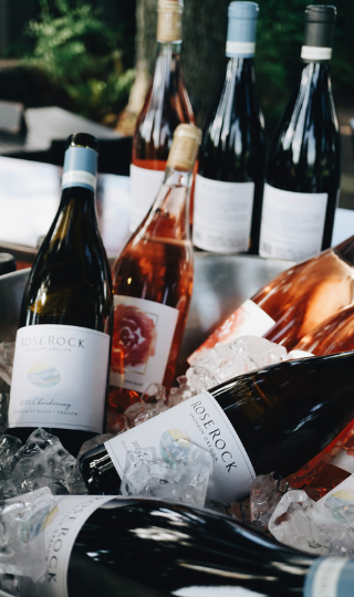 Four bottles of wine in an ice bucket.