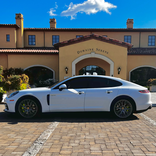 white porsche parked in front of Domaine Serene winery