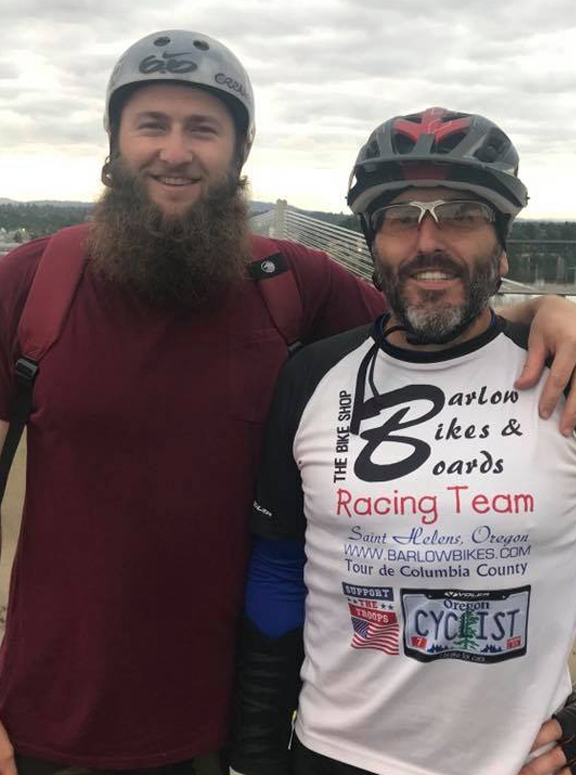 two people wearing bike helmets