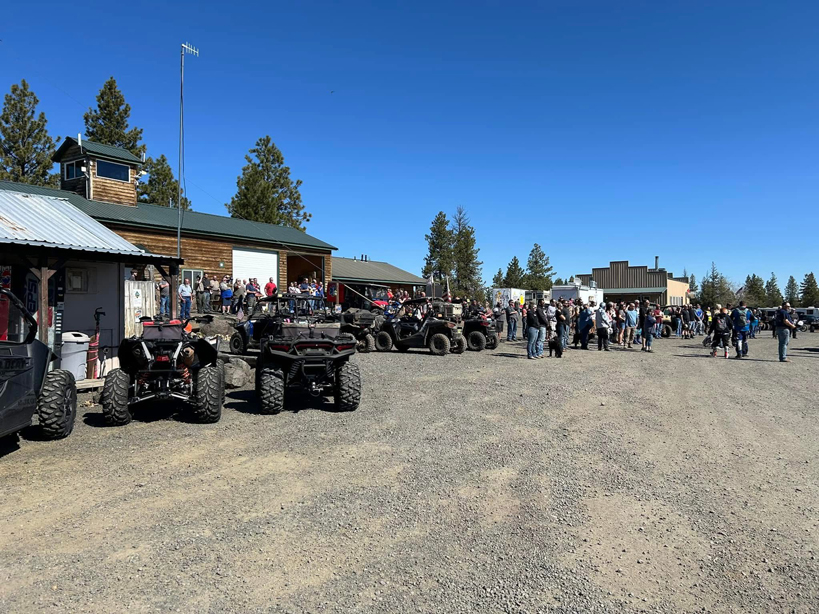 crowd at OHV Park with a number of parked ATVs