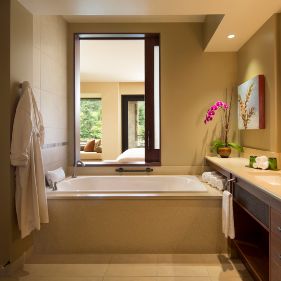 bathtub with window to hotel guest room