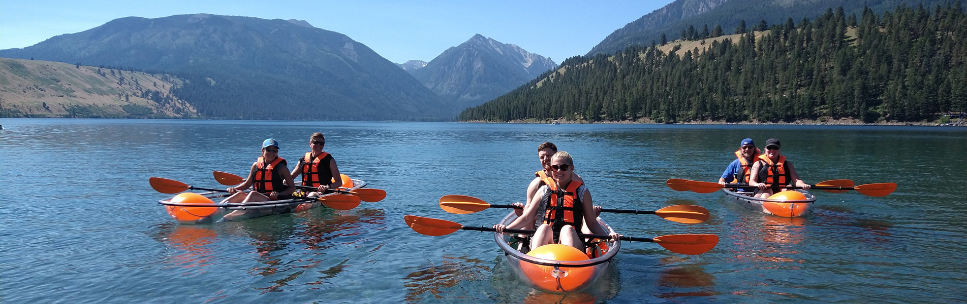 kayakers float on lake