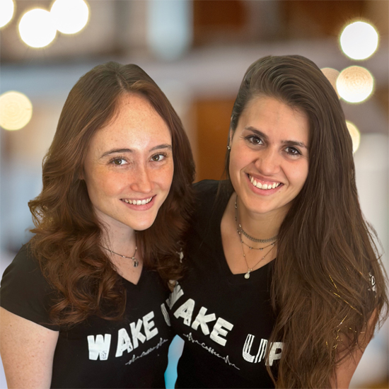 two people wearing tee shirts with lettering for wake up on them