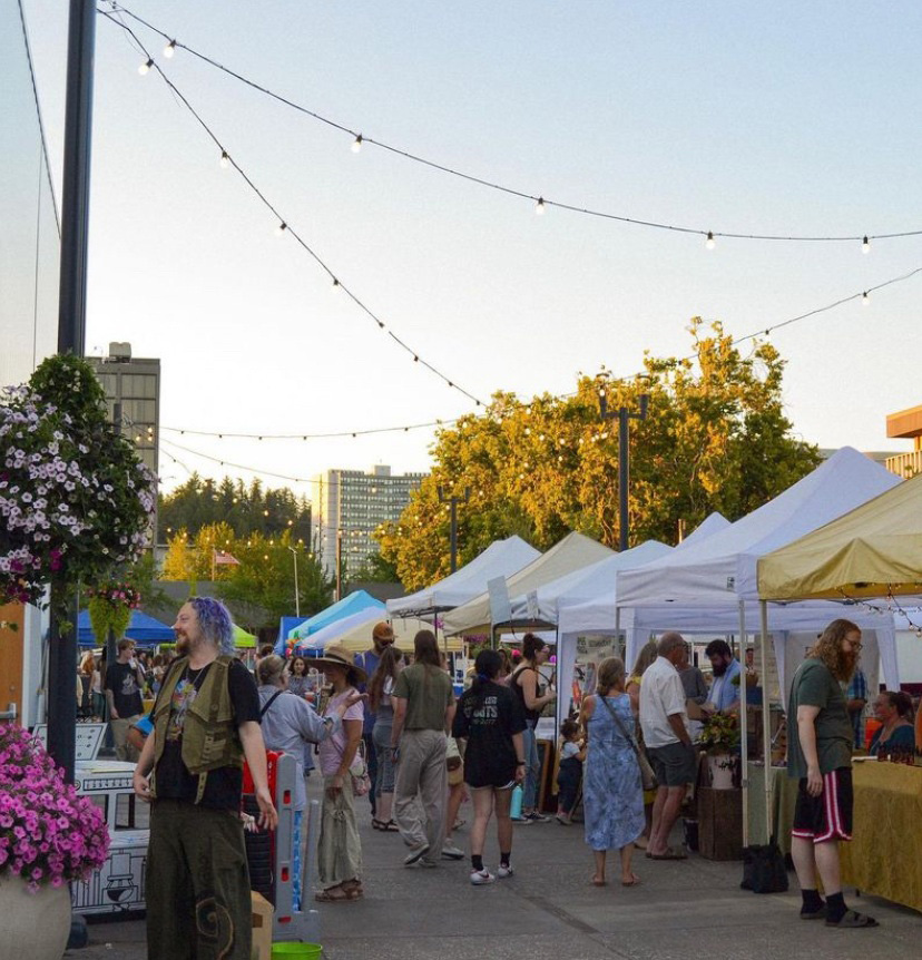 people shop booths at outdoor farmers market