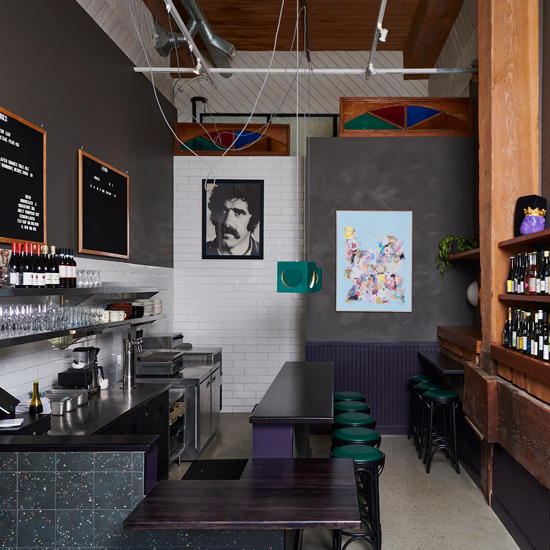 wine bar with modern fixtures and portrait of Frank Zappa on the wall