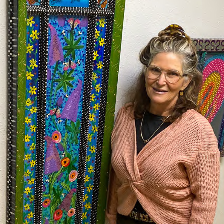 person standing next to painting