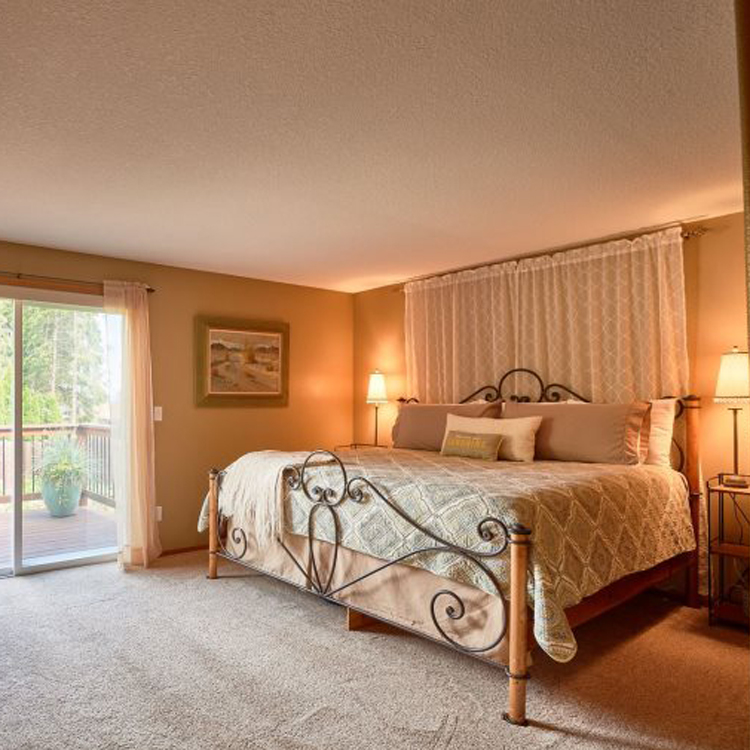bedroom with carpet and doors to outside patio