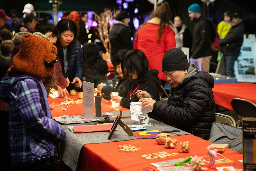 people making art at a vendor fair