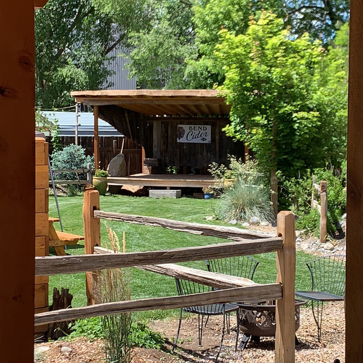wooden outdoor stage next to leafy tree