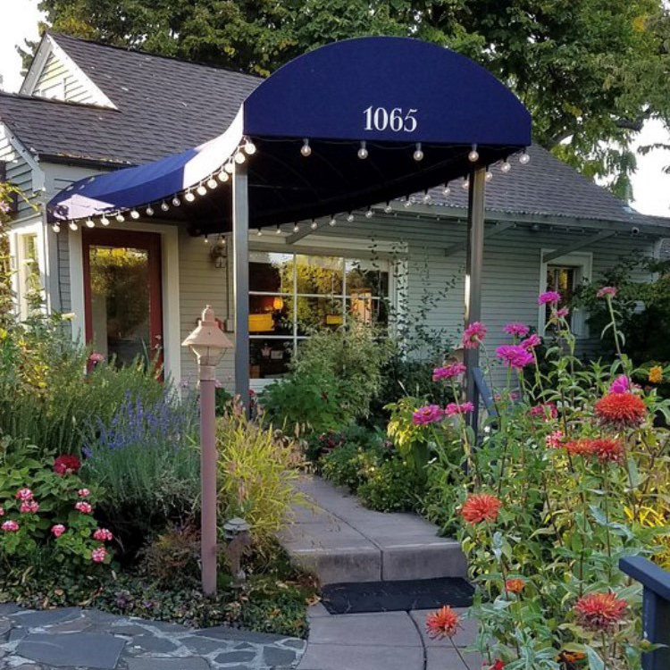 paved path to entrance of building covered by awning