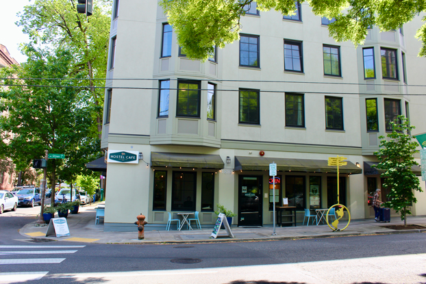 multi story commercial building with cafe seating on ground level