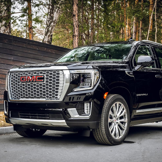 GMC Danali parked next to wood fence