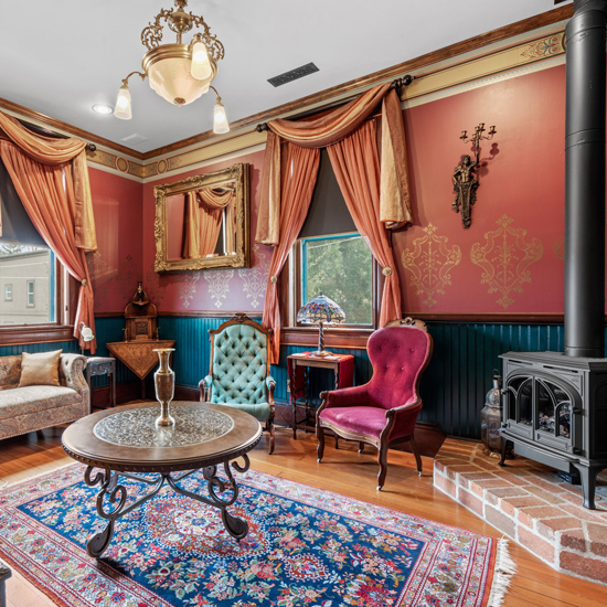 sitting area with woodstove and antique armchairs