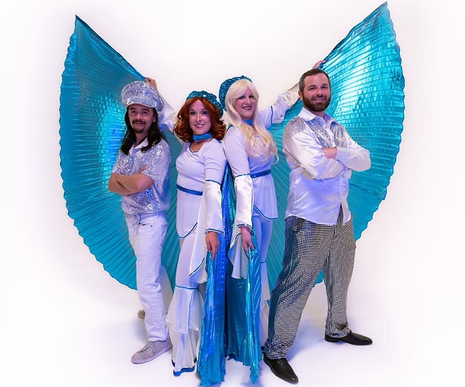 An ABBA tribute band poses for the camera.