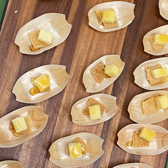 samples of cheese paired with cracker and honey