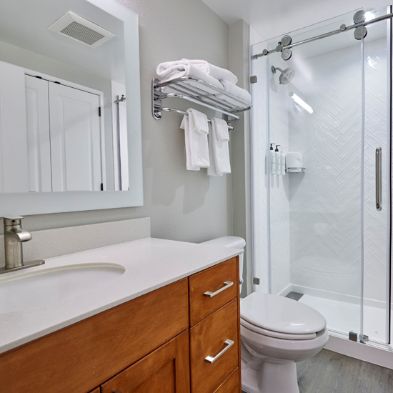 hotel room bathroom with sink, toilet and shower