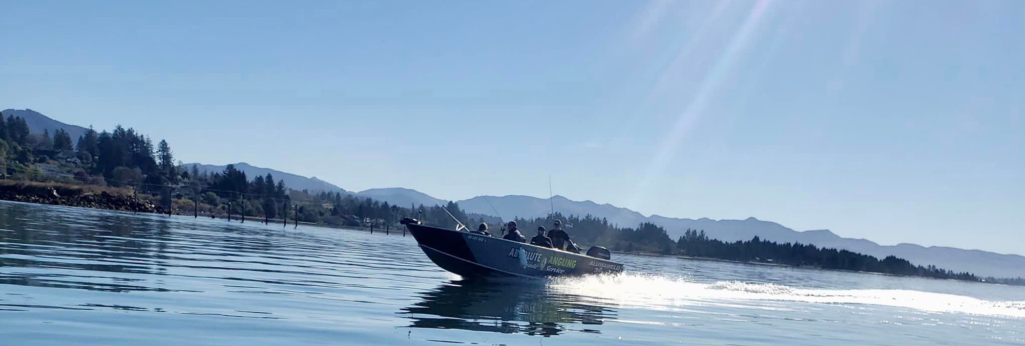 guide boat on a calm lake with the sun shining down