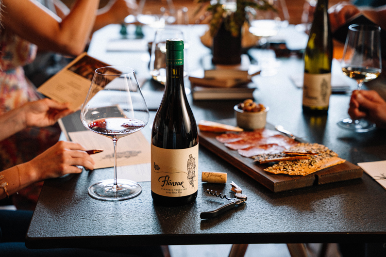 bottle of Flaneur wine its next to charcuterie board