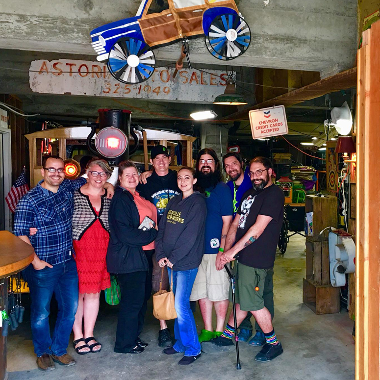 group of eight people pose for photo in underground tour space